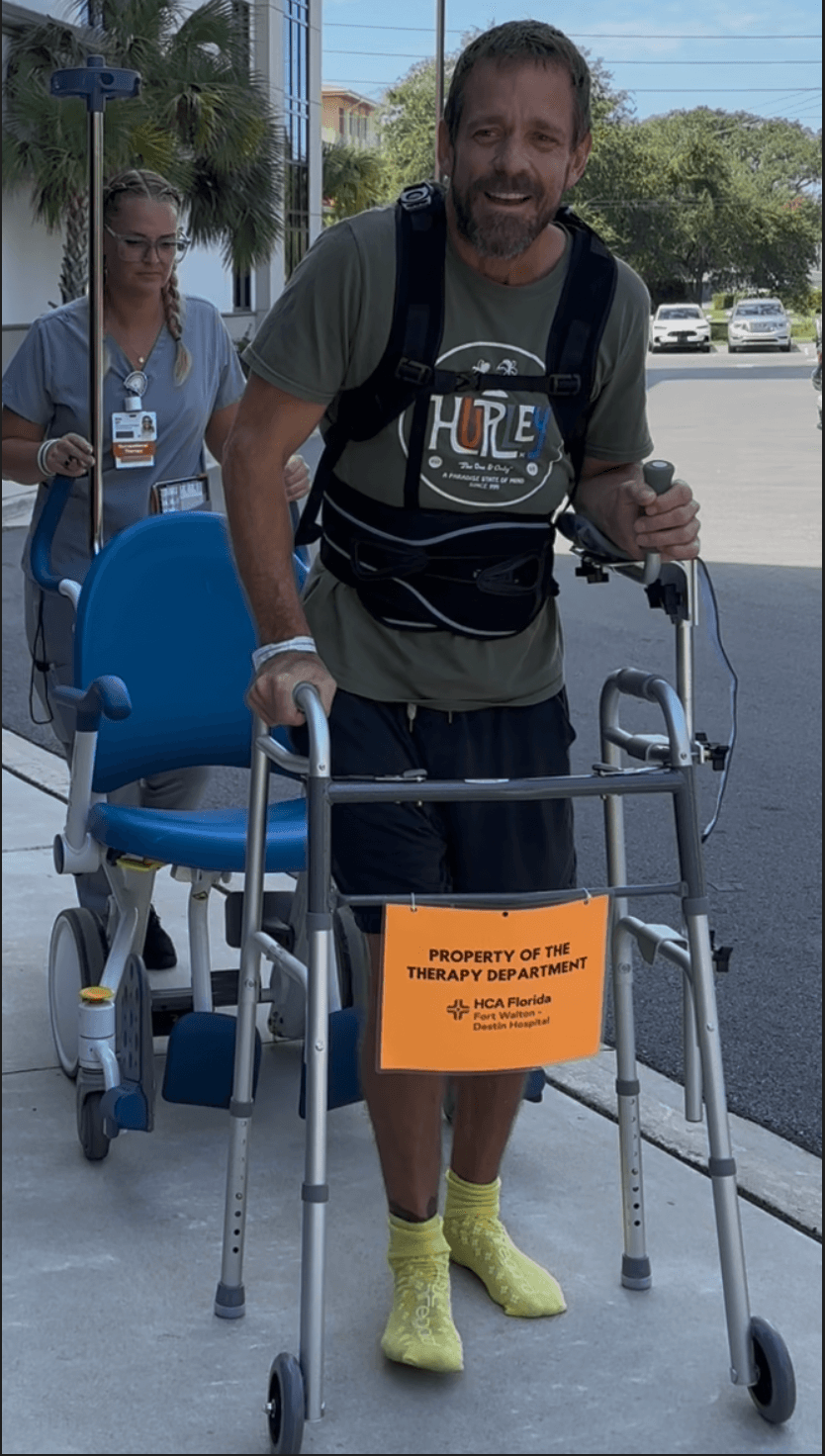 Michael Cavett walking with a walker outside the hospital