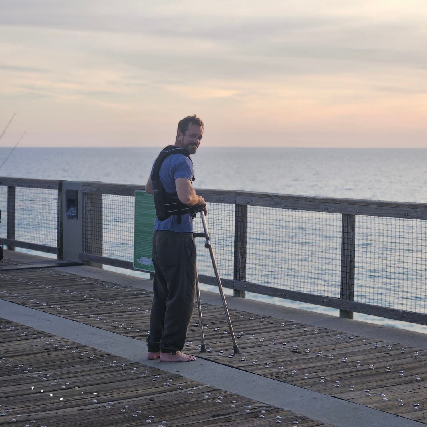 Michael Cavett smiling on a pier