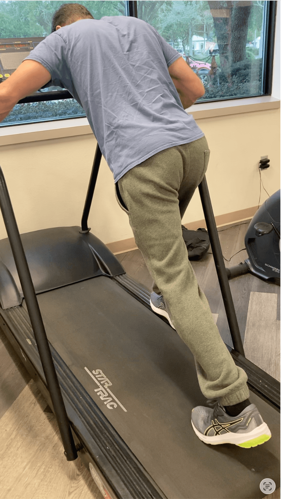 Michael Cavett on a treadmill balancing on one leg