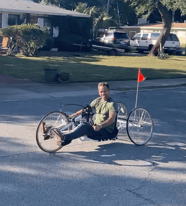 Michael Cavett riding a hand trike