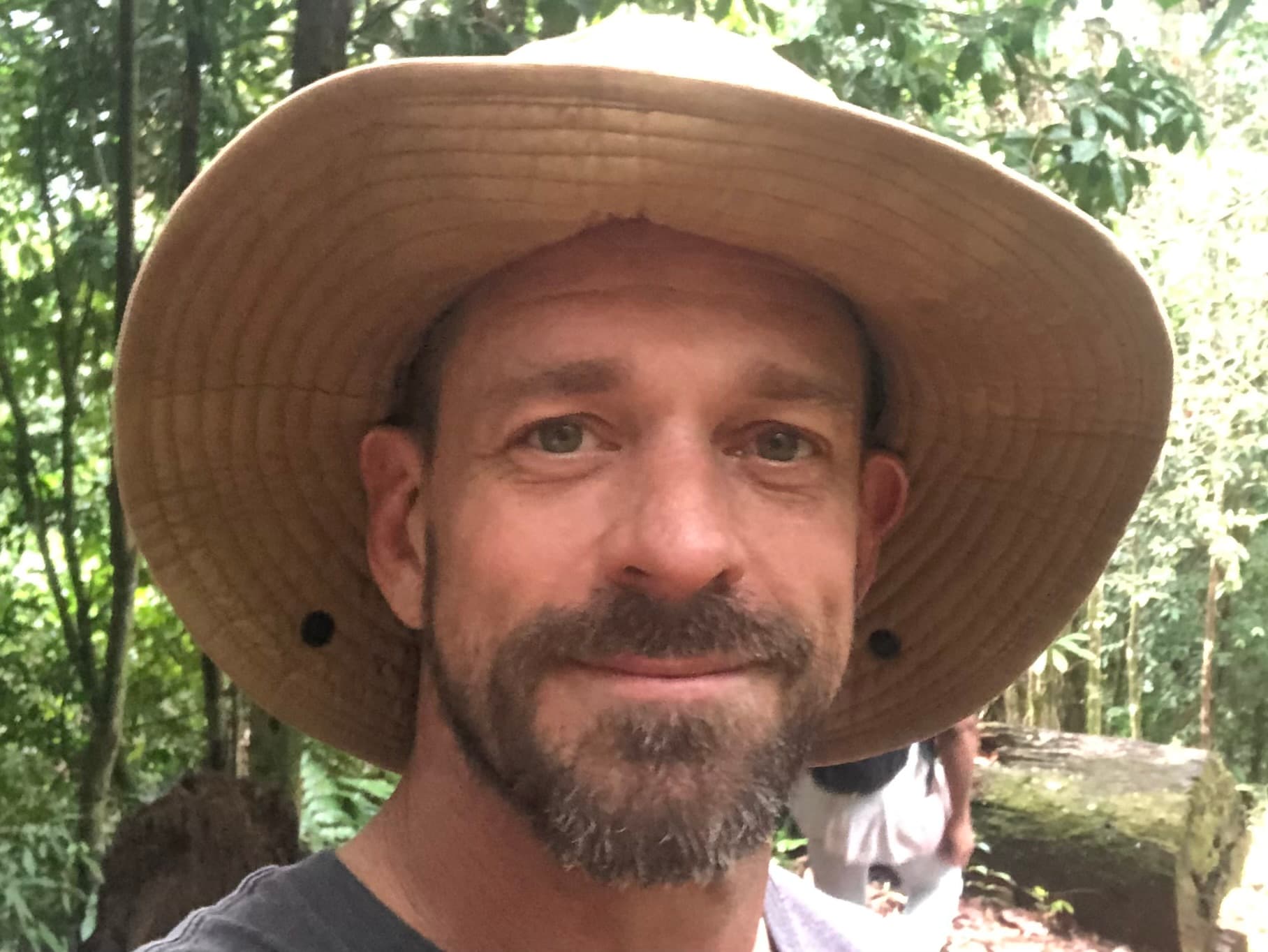 Michael Cavett wearing a hat in the jungle
