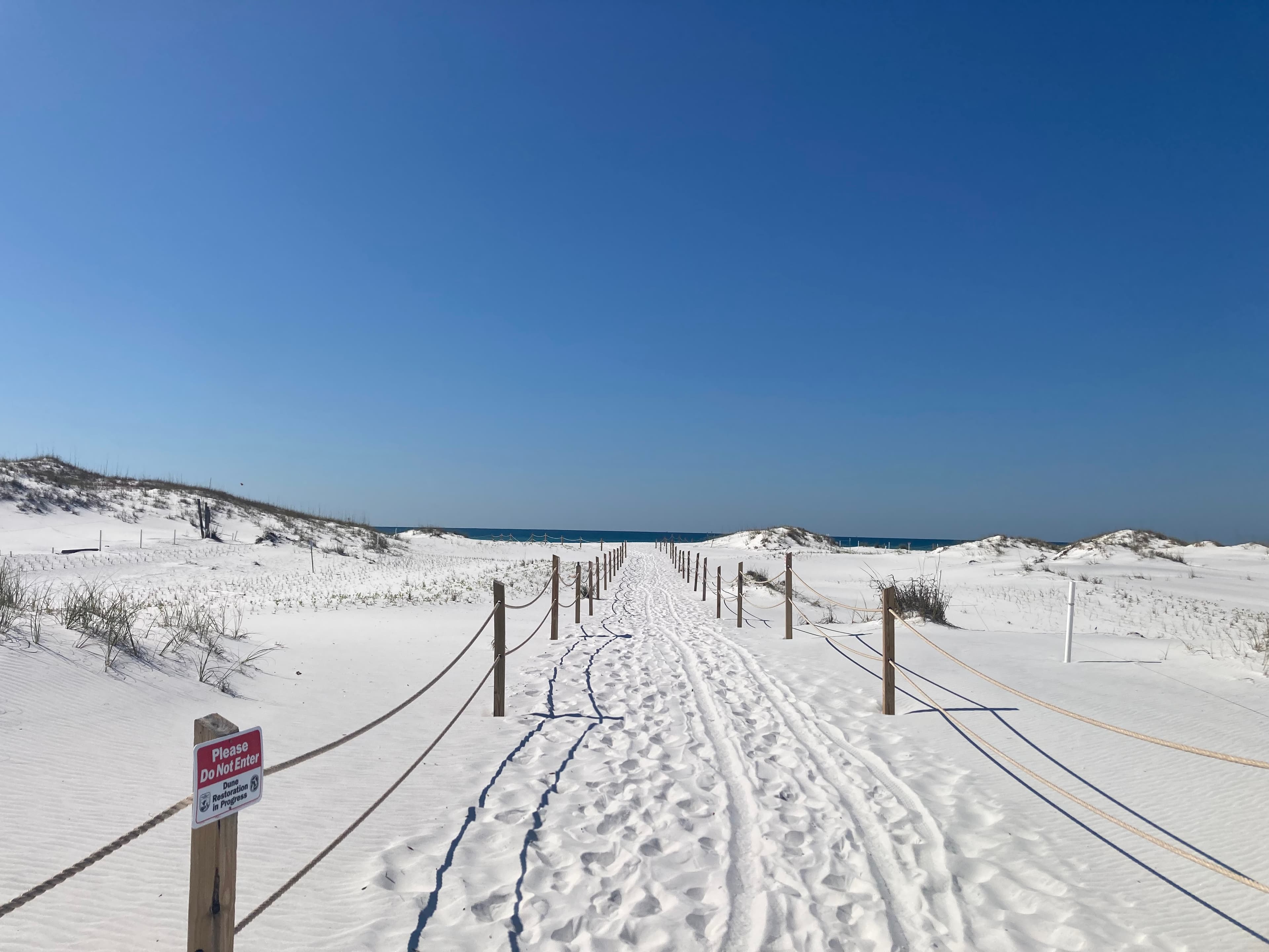 A sandy path through the dunes leading to the beach